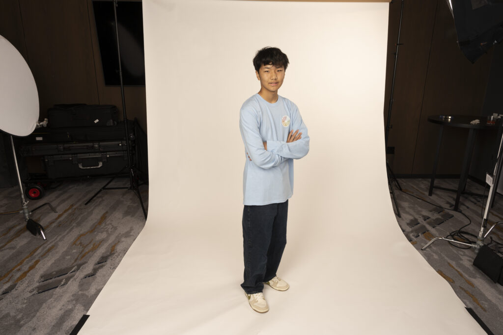 Evann Sun poses for a photo in a photography studio.