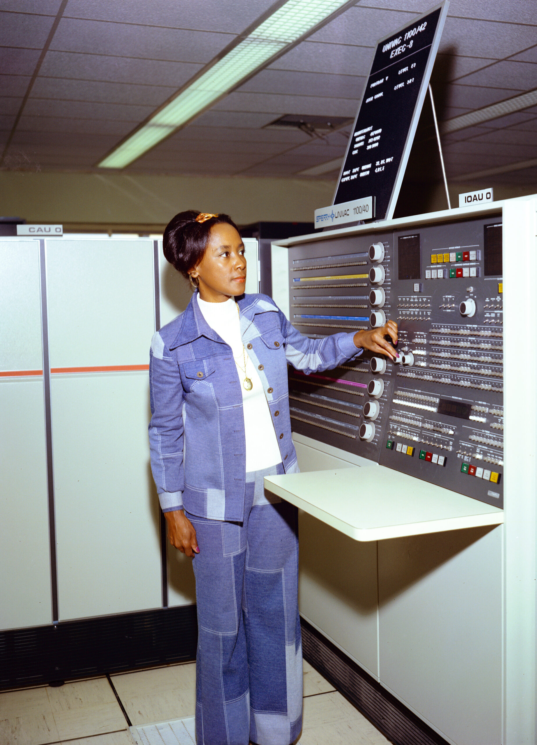 Annie Easley stands in front of a large universal automatic computer.