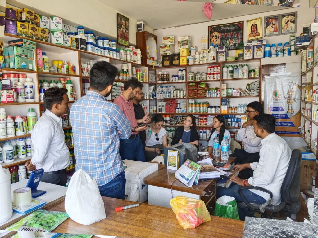 Nine people meeting in a pharmacy.