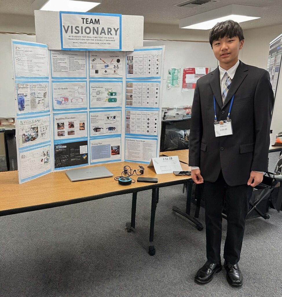 Evann Sun stands next to the Team Visionary project
