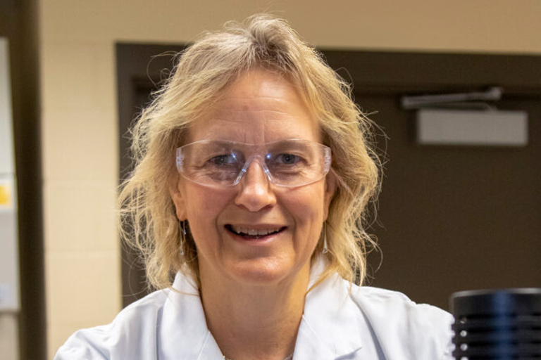 Audrey Sherman smiles while wearing protective eye glasses.