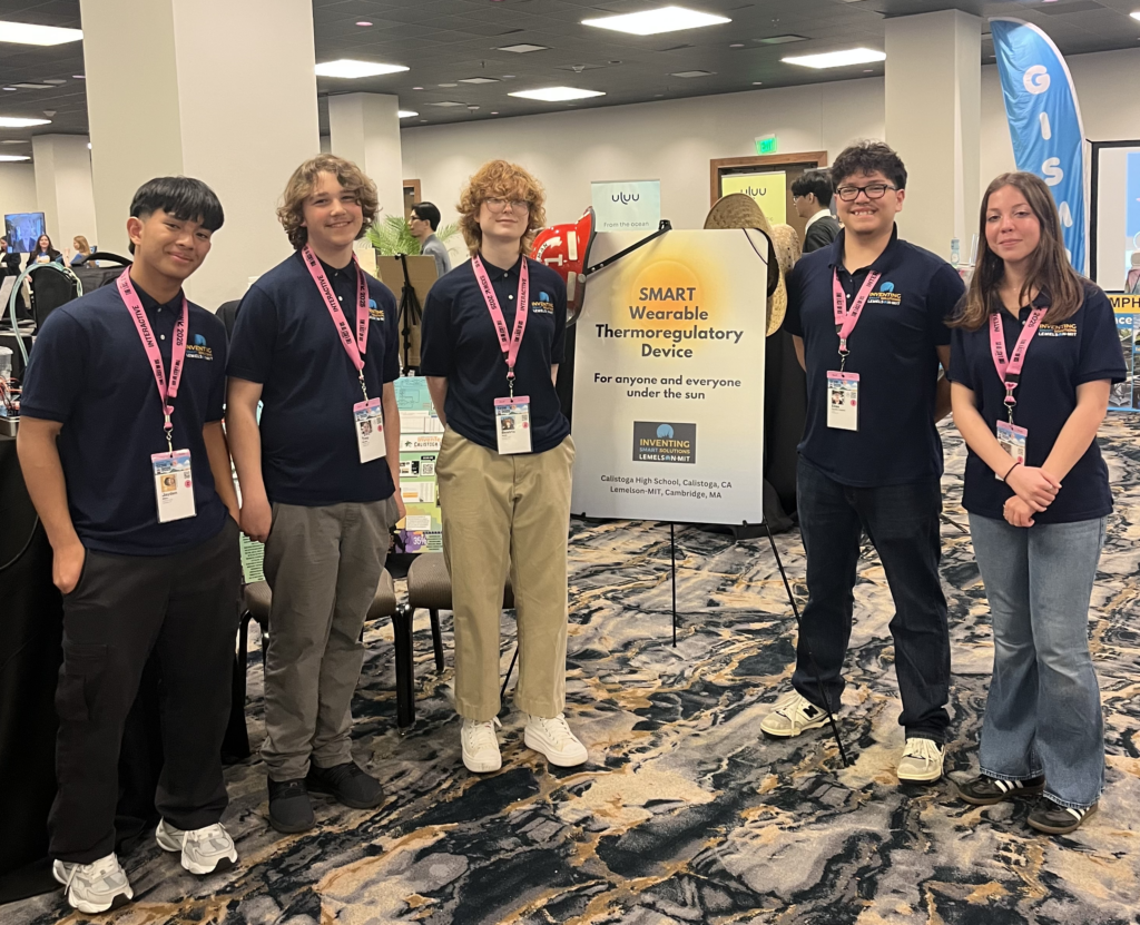Five students on the Calistoga InvenTeam are standing next to their banner for their invention of a SMART Wearable Thermoregulatory Device during the SXSW Innovation Awards.