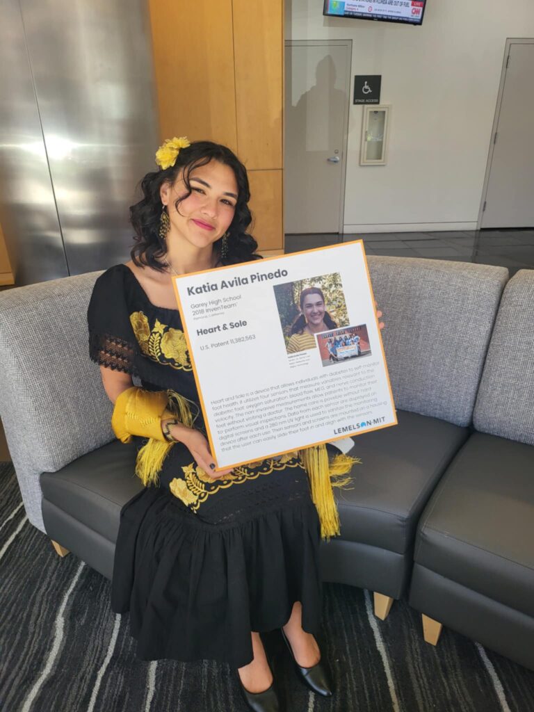 Katia Avila Pinedo in Washington, D.C. with a poster about the Heart & Sole invention.