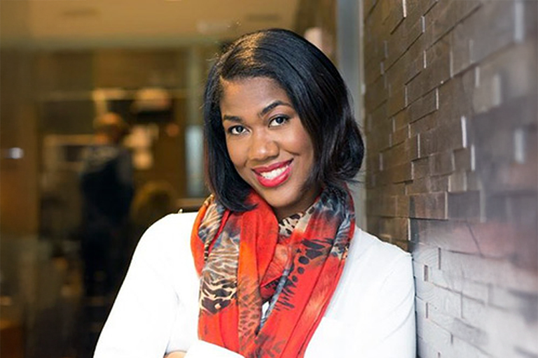 Tahira Reid Smith smiles in a headshot photo.
